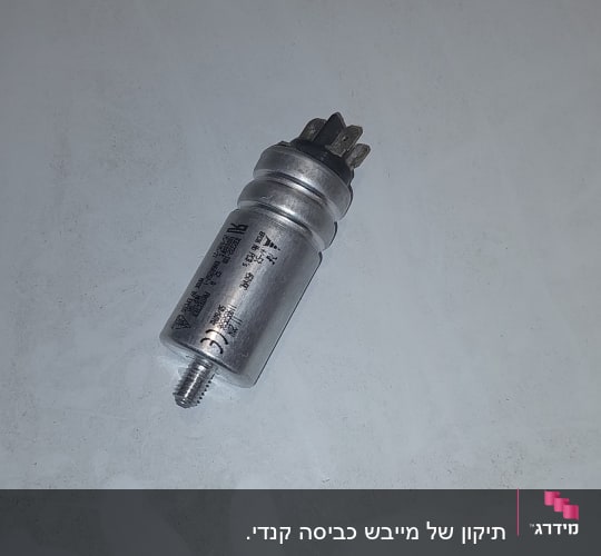 רכיב מתכת עם חיבורים חשמליים על שולחן לבן